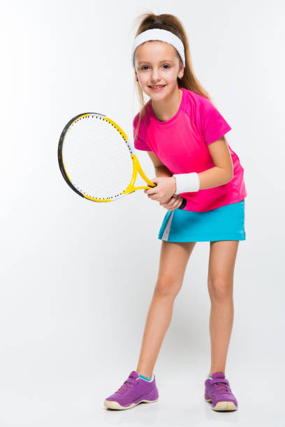 istock Cute little girl with tennis racket in her hands on white background 924256422