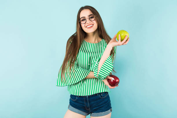 istock Young woman with two apples 924257278
