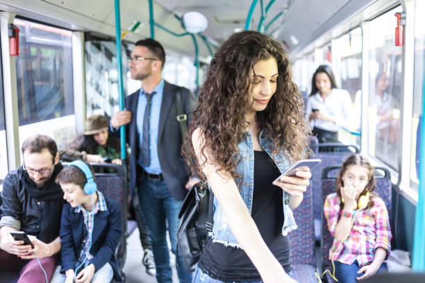 istock Woman with long hair using smart phone inside of a bus 924266414
