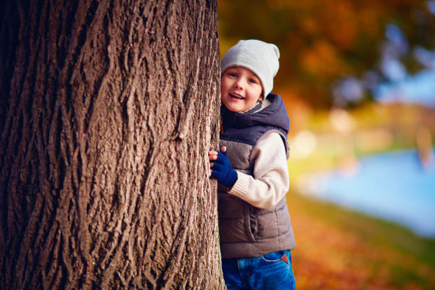 istock happy young boy having fun in autumn park 924267528