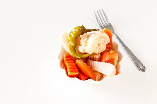 istock Assorted pickles vegetables in white bowl. Top view. Isolated. 924279422