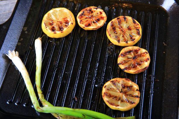 Cast iron grill pan with scallion, lime slices