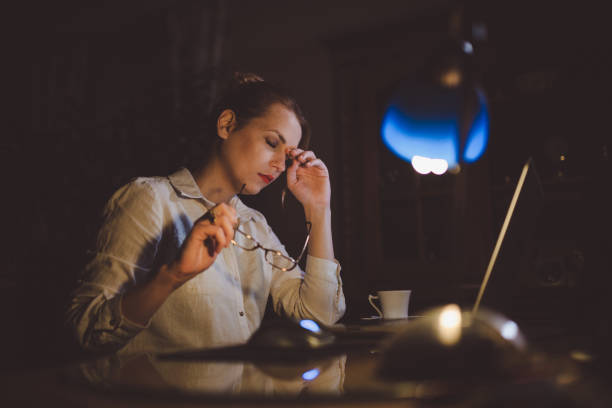 istock Young woman working from home office in the night hours 924284628