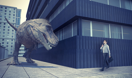 Empresario caminando en la ciudad y un dinosaurio le está esperando la vuelta de la esquina. photo