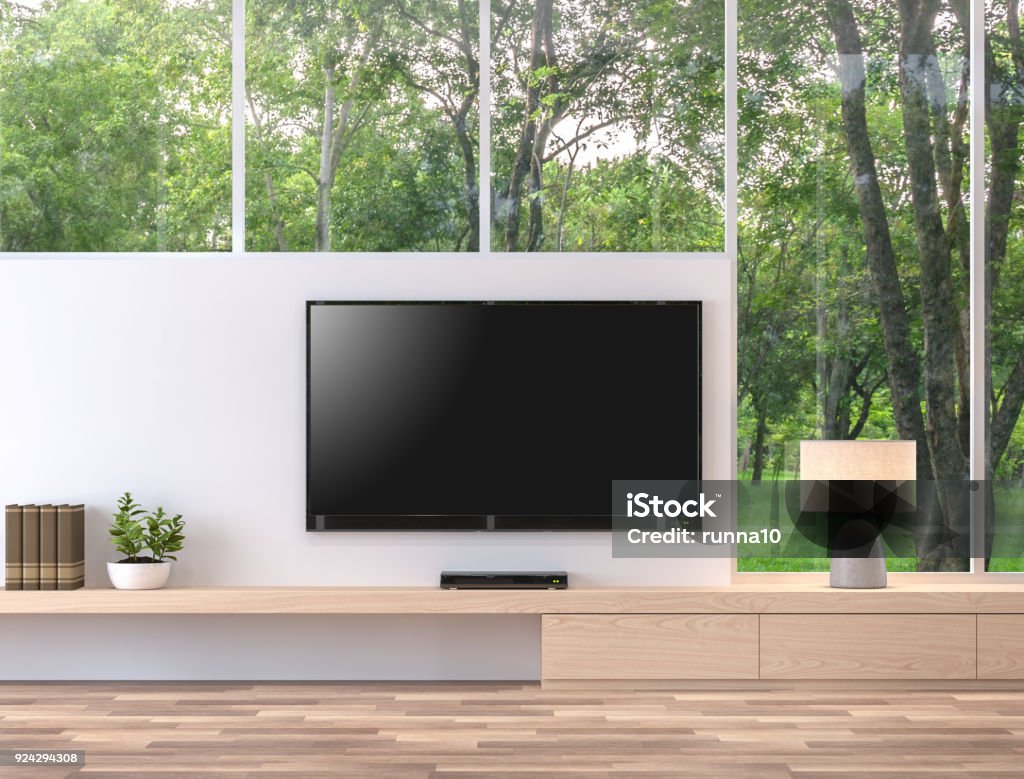 Empty television screen with nature view 3d render. Empty television screen with nature view 3d render.There are wood floor,wood shelf and white wall. There is a clipping path to the tv screen. Television Set Stock Photo