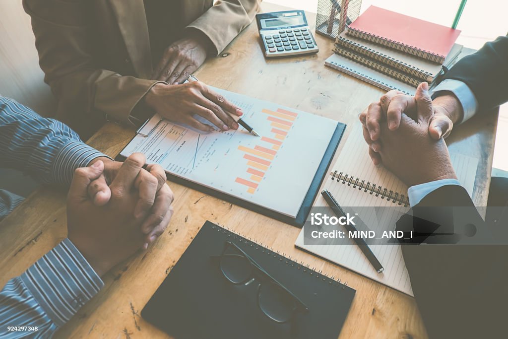 Business concept. Business people discussing the charts and graphs showing the results of their successful teamwork. Success Stock Photo