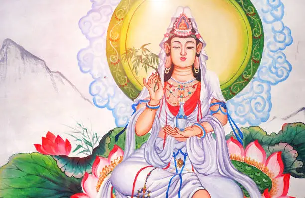 Photo of white Guan Yin lady chinese god wall paint at local public chinese temple in Chiangmai Thailand - the Goddess of Mercy and Compassion in the buddhist religion