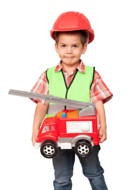 istock child in a red helmet and with a fire engine 924308066