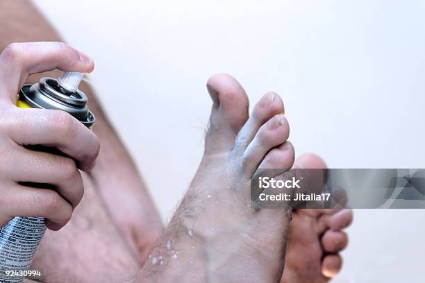 Man With Athletes Foot Spraying Medication Closeup Stock Photo - Download Image Now