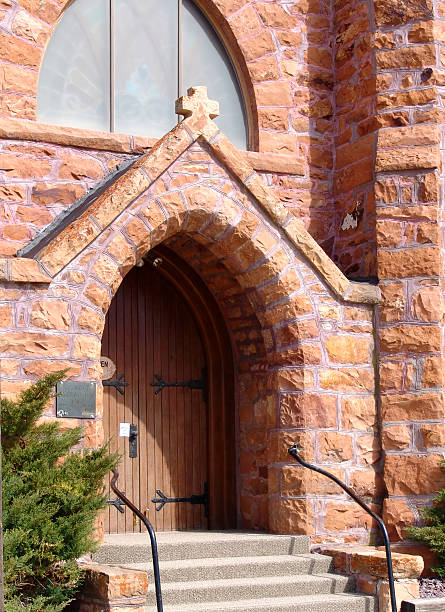 istock An older brick church with an arch doorway. 92431263
