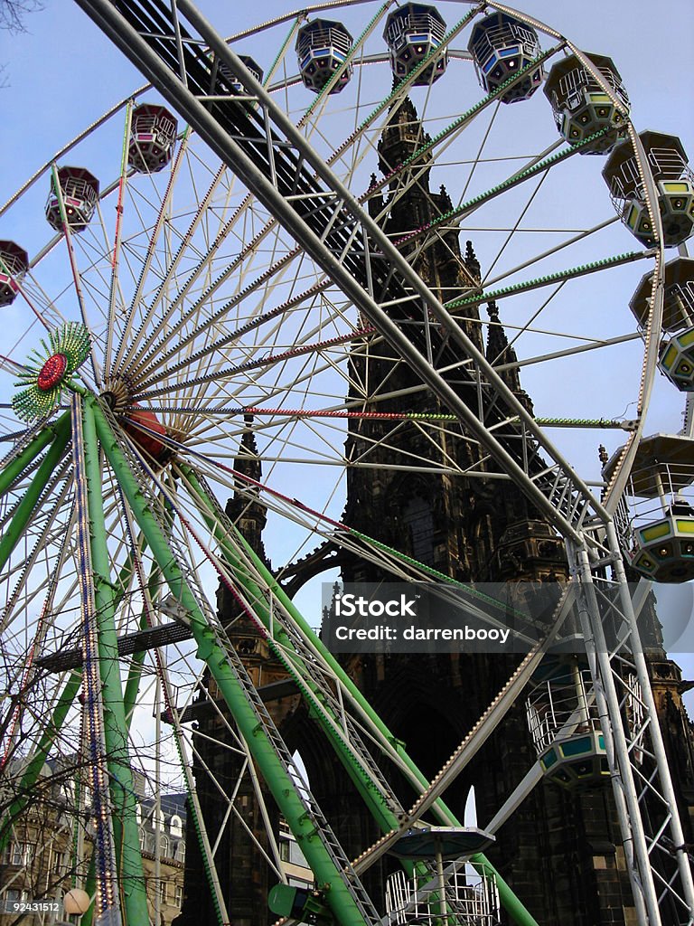 Ferris Wheel and Gothic Church  Amusement Park Ride Stock Photo