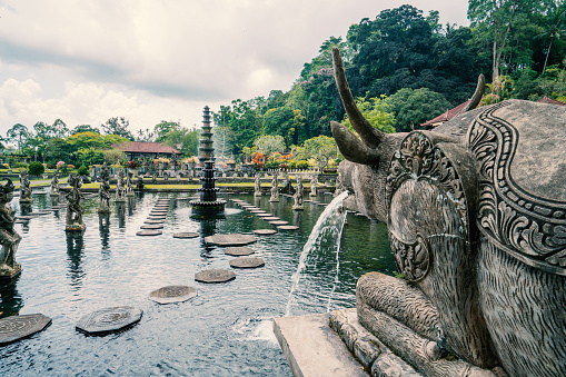 Royal water garden on sunny day in Tirtagangga, Bali\nBeautiful Tirta Gangga temple or water temple, Bali, Indonesia