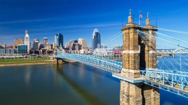 Cincinnati's Roebling Suspension Bridge With Downtown Skyline, Elevated View Elevated view of the Roebling Suspension Bridge with Downtown Cincinnati skyline in the background and the Ohio River just below. ohio river photos stock pictures, royalty-free photos & images