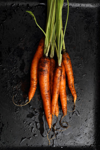 istock Farm carrots on a black background 924322396