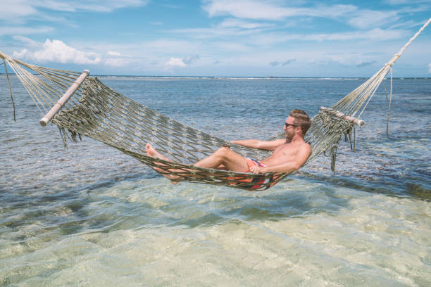istock Cheerful man relaxing on sea hammock tropical climate 924323166