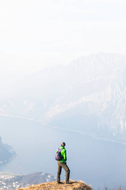 istock Hiker standing on mountain over lake 924337184
