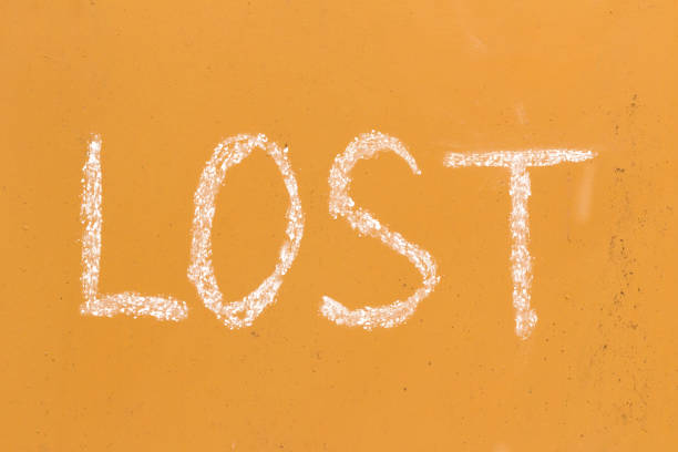 istock Word lost handwriting with white chalk on old orange metal background 924337200