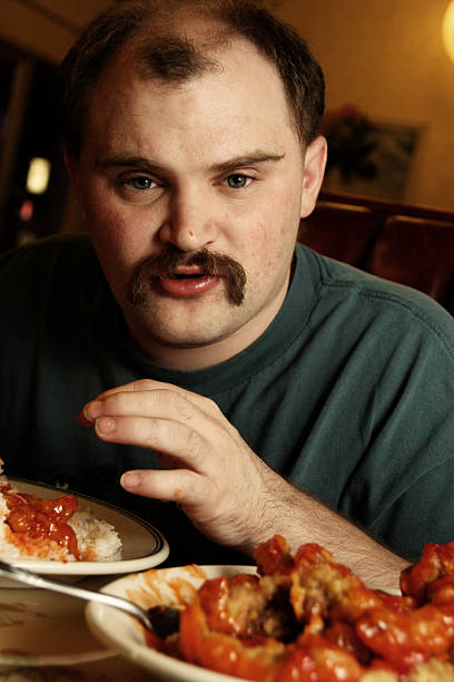 Guy Eating Chinese Food for Dinner a man eating chinese food chinese ethnicity china restaurant eating stock pictures, royalty-free photos & images