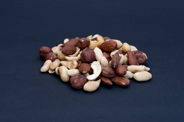 istock Variety of nuts isolated on a black background. 924343938