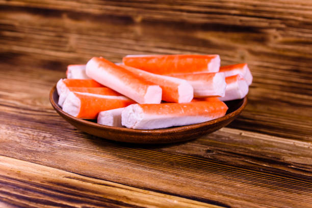 istock Ceramic plate with crab sticks on wooden table 924345962
