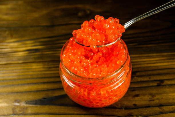 istock Red caviar in a spoon above the glass jar 924348174