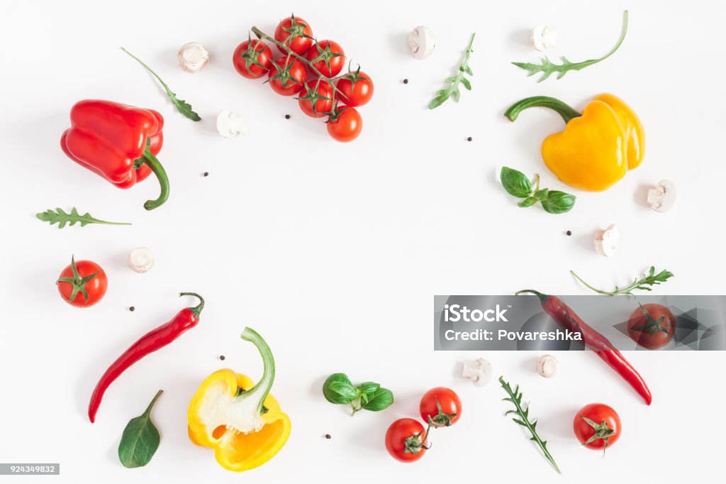 Healthy food on white background. Flat lay, top view Healthy food on white background. Vegetables, tomatoes, peppers, green leaves, mushrooms. Flat lay, top view, copy space Vegetable Stock Photo