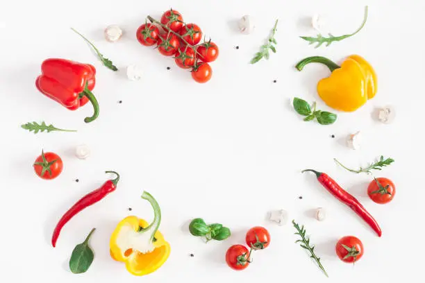 Healthy food on white background. Vegetables, tomatoes, peppers, green leaves, mushrooms. Flat lay, top view, copy space