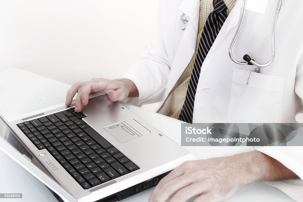 Doctor working on a laptop  Correspondence Stock Photo