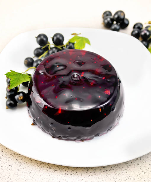 istock Jelly from black currant with berries in plate on table 924353066