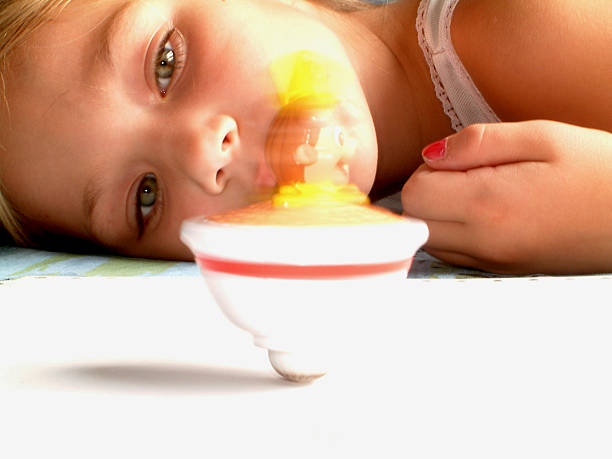Child playing sliding inside tube or pipe of great metal slide