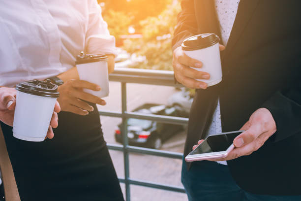 istock Manager showing smartphone to employee in morning before work. 924364852