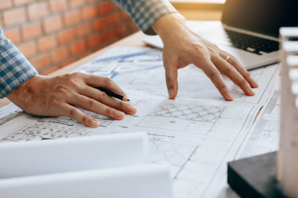 istock Young engineer man looking on blueprint paper. 924365050