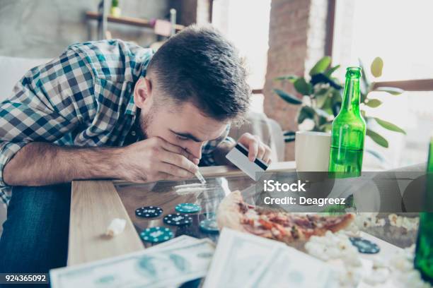 Close Up Portrait Of Exhausted Drunk Overdosed Guy Dressed In Checkered Shirt He Is Sniffing A Snorting Line Made Of Drugs On A Table Stock Photo - Download Image Now