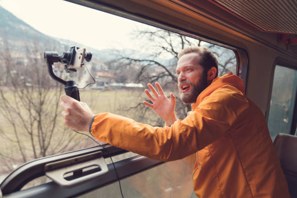 Influencer traveling in train and vlogging Young man recording video for his blog while travelling in train persuasion photos stock pictures, royalty-free photos & images