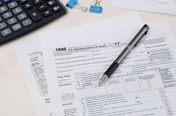 istock US tax form 1040 with pen and calculator 924372590