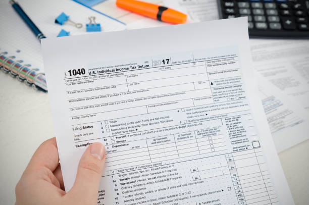 istock Man filling US tax form. 924372696