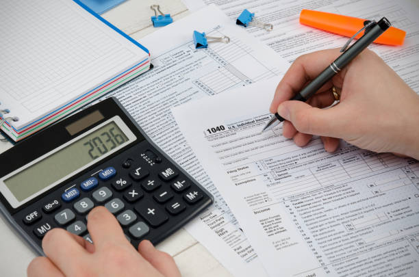 istock Man filling US tax form. 924372758
