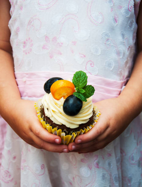 istock Little girl holding cupcake 924372766