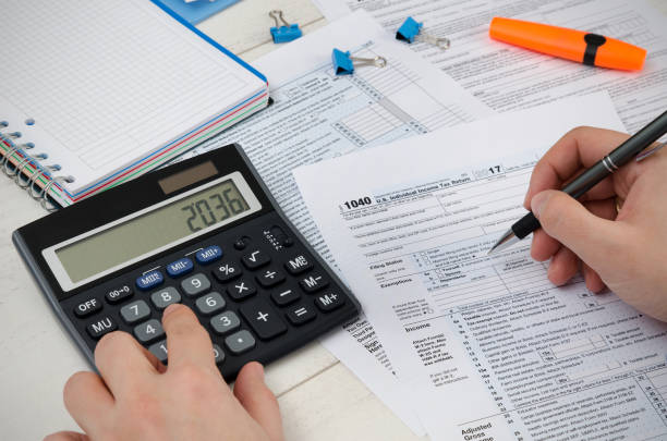 istock Man filling US tax form. 924372836