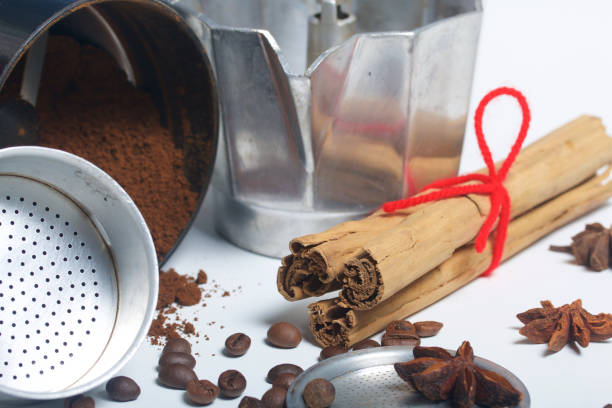 istock A geyser coffee machine in disassembled form is on the table. It is visible ground coffee in a coffee grinder and spices: a anise, a carnation,  cinnamon and fragrant pepper. 924375612