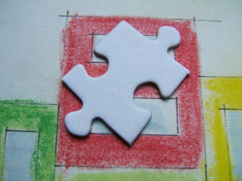 A close-up shot of a jigsaw puzzle on a wooden table.