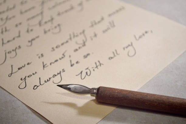 female hand writes with the inky pen the word letter on a white paper sheet with stripes. stationery on desk close up top view. spelling lessons and caligraphy exercises. Template, layout, background.