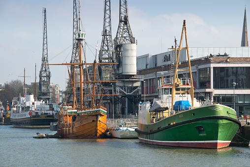 Bristol Docks & harbourside, showing the Clifton Suspension Bridge, cranes, the Matthew (wooden ship), ferries, City Centre, hand statue, marina etc.