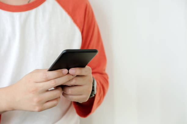 istock Man hand using black smart phone over white background, technology and lifestyle 924389160