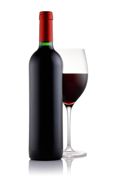 istock Bottle and a glass filled with red wine isolated on white background 924389170
