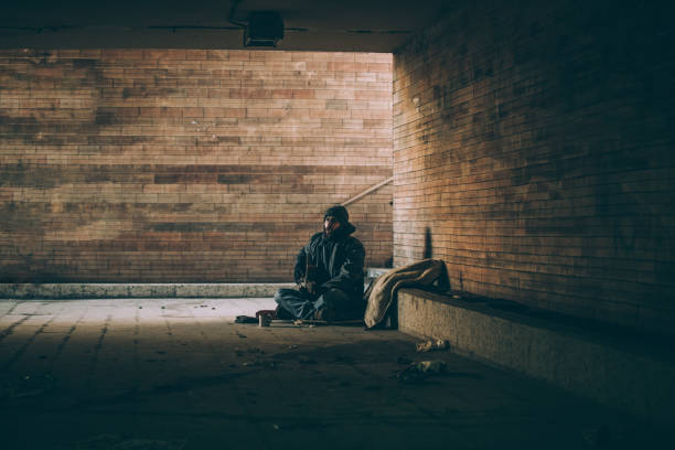 istock Homeless young man playing guitar 924399052