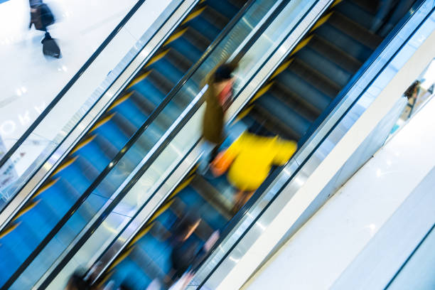 istock Motion blur people at the escalator 924399740