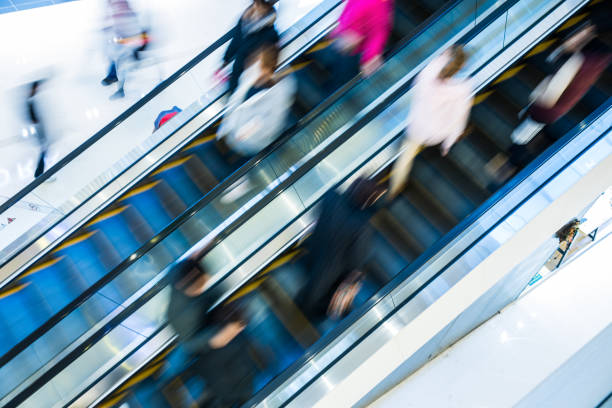 istock Motion blur people at the escalator 924399742