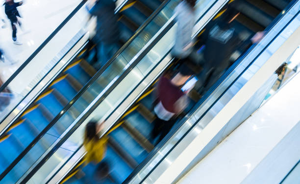 istock Motion blur people at the escalator 924399826