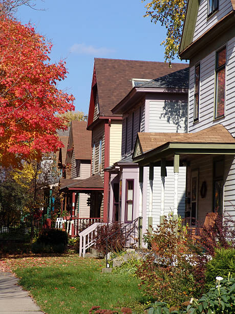 istock Row of Overgrown Older Houses with Fall Foliage. 92440059